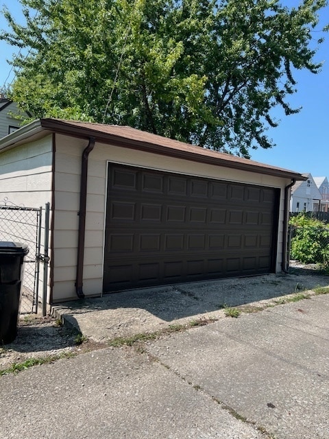 detached garage featuring fence