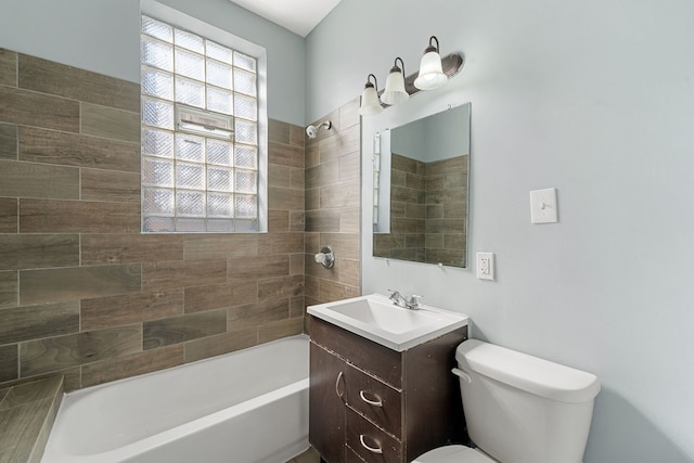 full bathroom featuring toilet, tiled shower / bath combo, and vanity