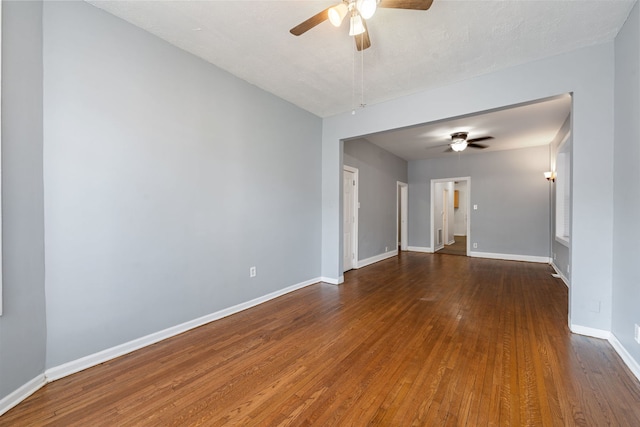 unfurnished room featuring dark wood-type flooring, a textured ceiling, and ceiling fan