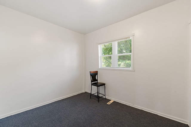 empty room featuring dark carpet