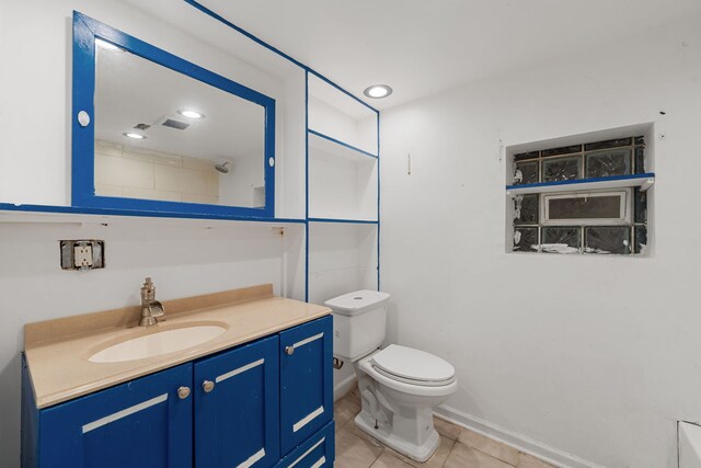 bathroom featuring tile patterned flooring, vanity, and toilet