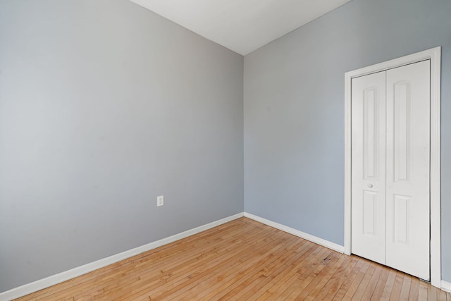 spare room with hardwood / wood-style floors