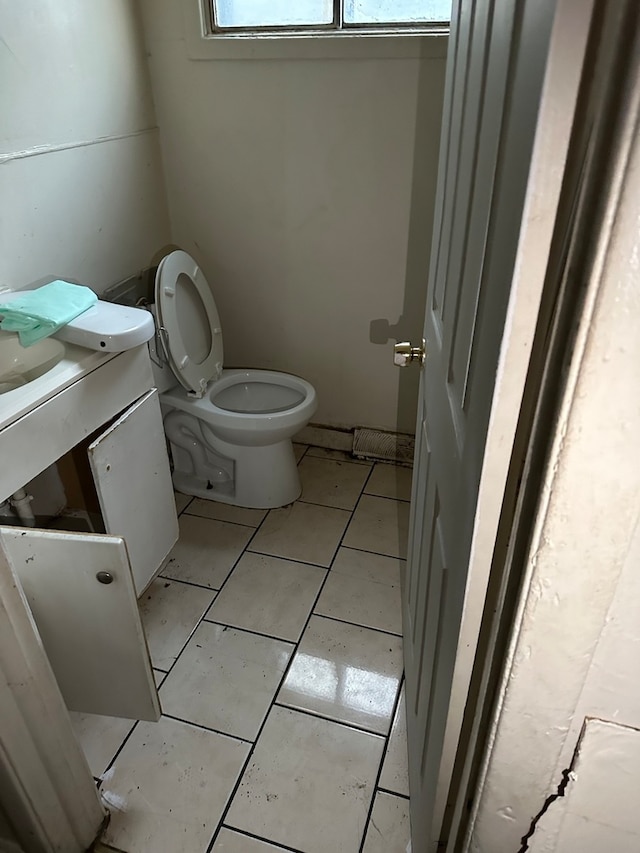 bathroom with vanity, toilet, and tile patterned floors