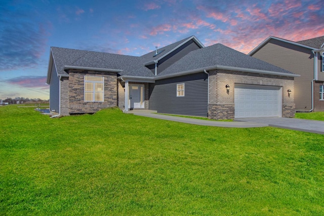 view of front of property featuring a garage and a yard