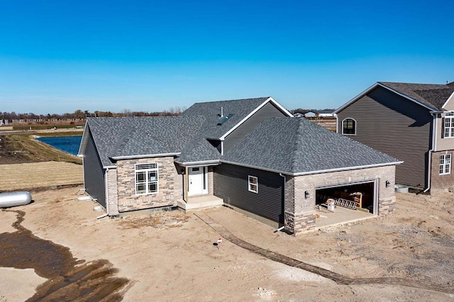 view of front of home featuring an attached garage and roof with shingles