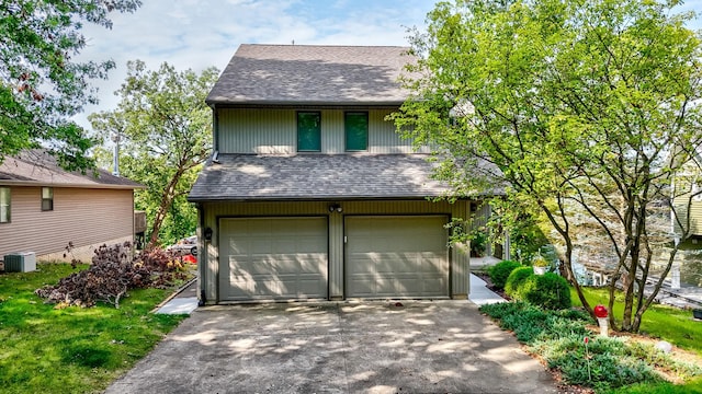 garage featuring driveway and cooling unit