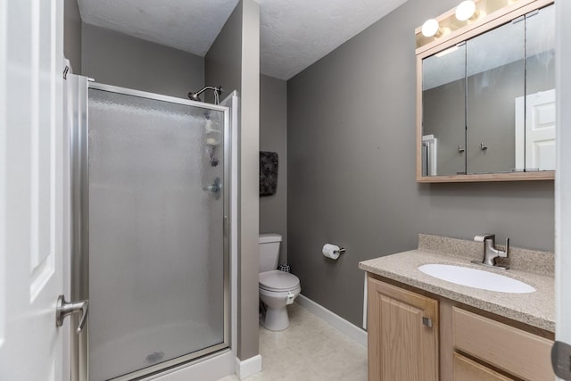 full bath with a stall shower, vanity, toilet, and baseboards