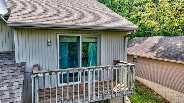 exterior space featuring roof with shingles