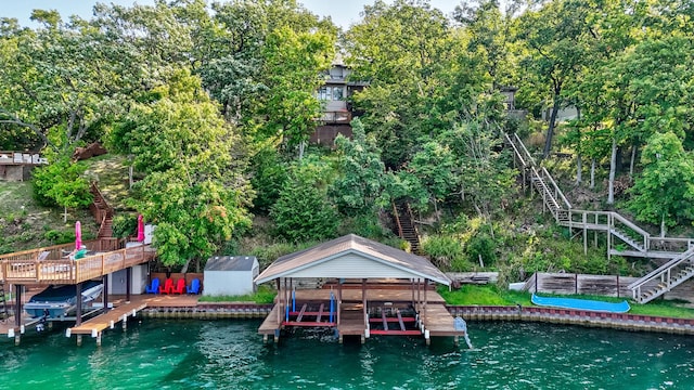 view of dock featuring stairway, a water view, and boat lift