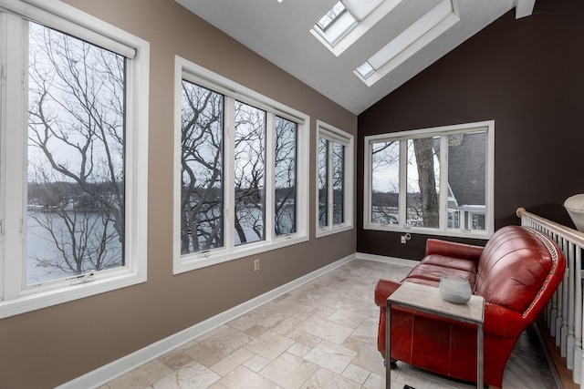 sunroom / solarium with vaulted ceiling with skylight