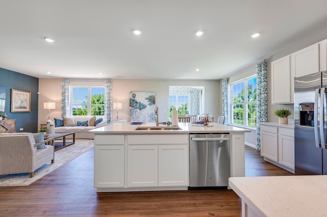 kitchen featuring white cabinets, stainless steel appliances, dark hardwood / wood-style flooring, and sink