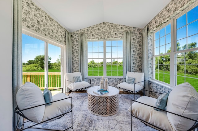 sunroom / solarium featuring vaulted ceiling