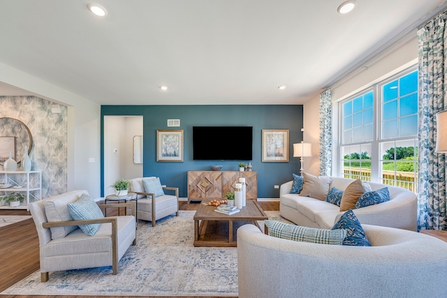 living area featuring baseboards, wood finished floors, and recessed lighting