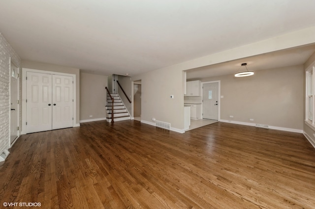 unfurnished living room featuring hardwood / wood-style flooring