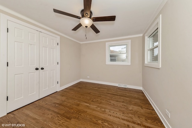 empty room with crown molding, hardwood / wood-style floors, and ceiling fan