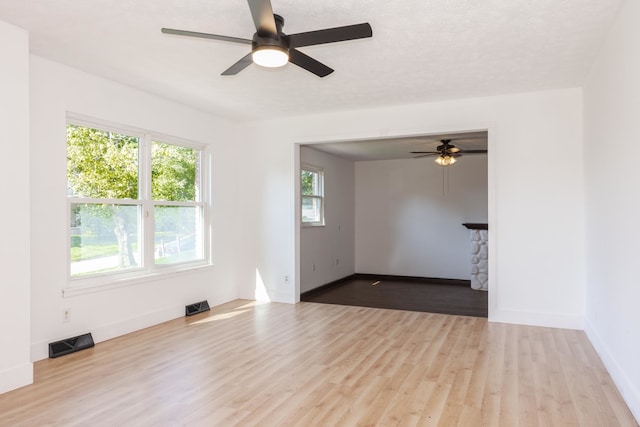 unfurnished room with ceiling fan and light hardwood / wood-style floors