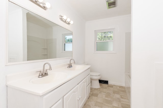 bathroom featuring toilet, vanity, and crown molding