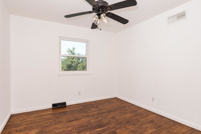 empty room with dark hardwood / wood-style flooring and ceiling fan