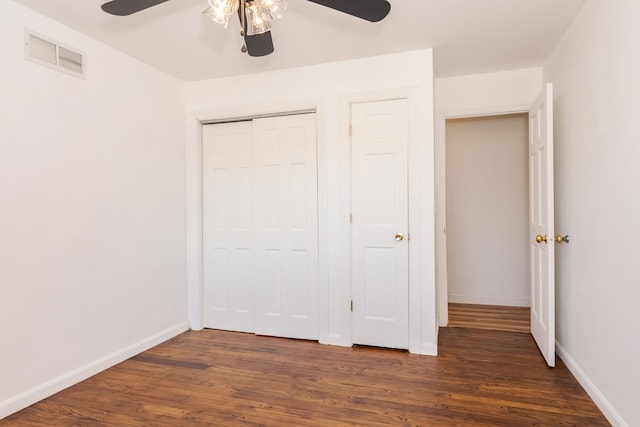 unfurnished bedroom featuring a closet, ceiling fan, and dark hardwood / wood-style flooring