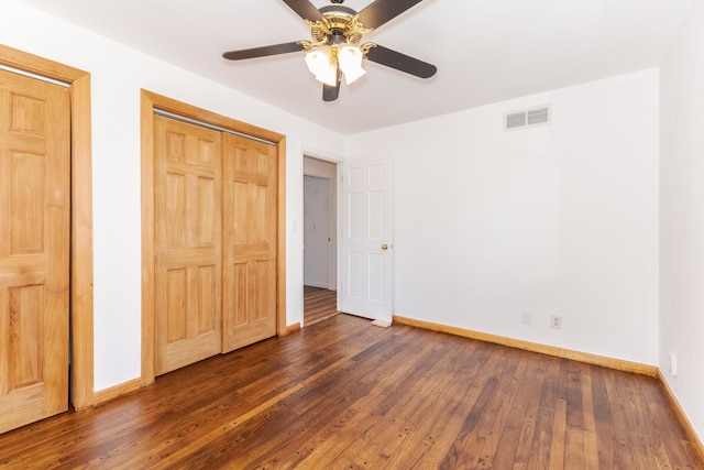 unfurnished bedroom featuring ceiling fan and dark hardwood / wood-style floors