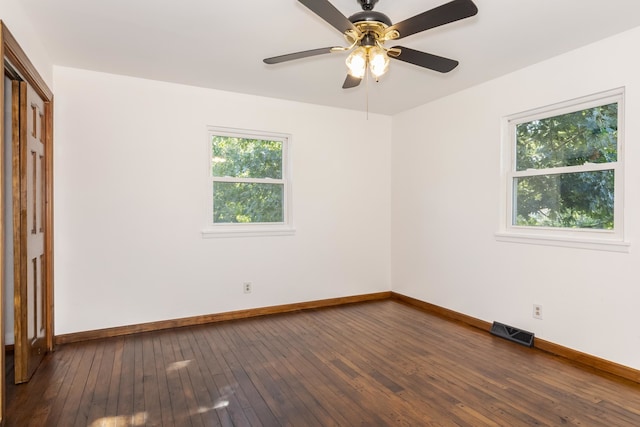 unfurnished room featuring dark wood-type flooring and ceiling fan