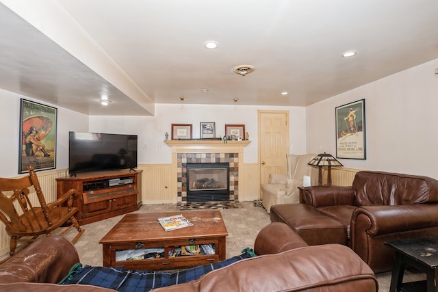 living room with light colored carpet and a tile fireplace