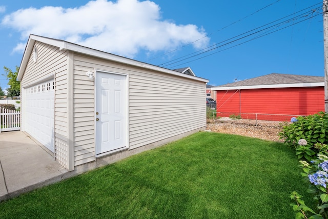 view of outdoor structure featuring a yard and a garage