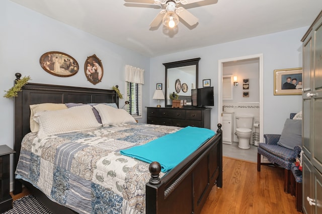 bedroom with wood-type flooring, ensuite bathroom, and ceiling fan