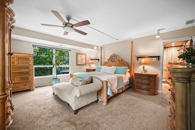 carpeted bedroom featuring ensuite bath and ceiling fan