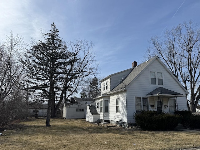 view of front of house with entry steps, an attached garage, a lawn, and roof with shingles