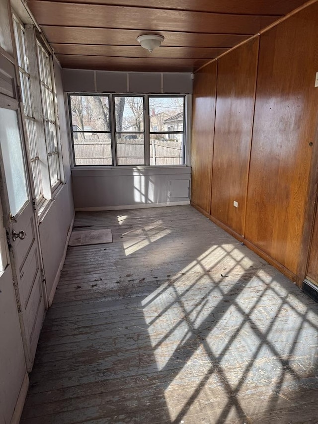 unfurnished sunroom featuring wooden ceiling