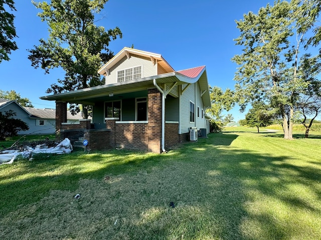 view of home's exterior featuring a yard and central air condition unit