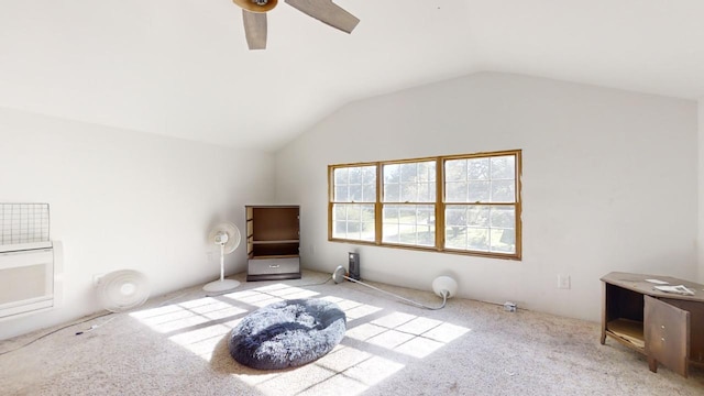 interior space with lofted ceiling, ceiling fan, and light carpet