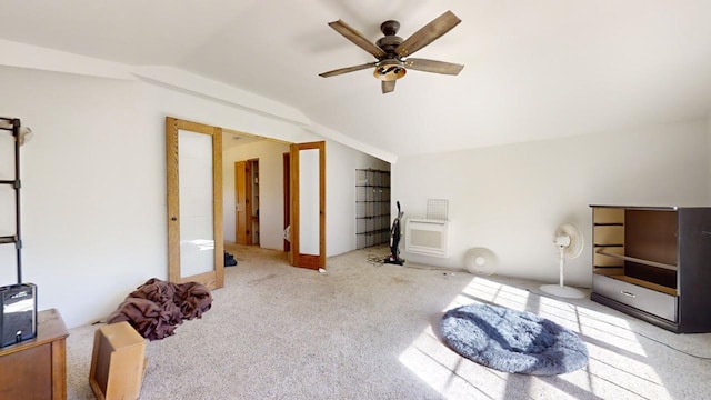 interior space with lofted ceiling, light colored carpet, and ceiling fan