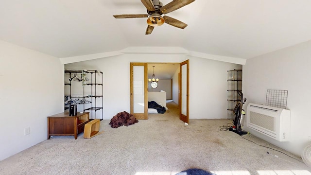 interior space featuring vaulted ceiling, ceiling fan with notable chandelier, carpet floors, and heating unit