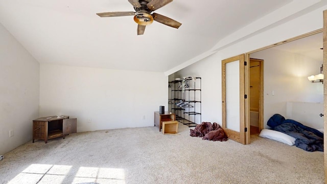 interior space featuring lofted ceiling, ceiling fan, and carpet floors