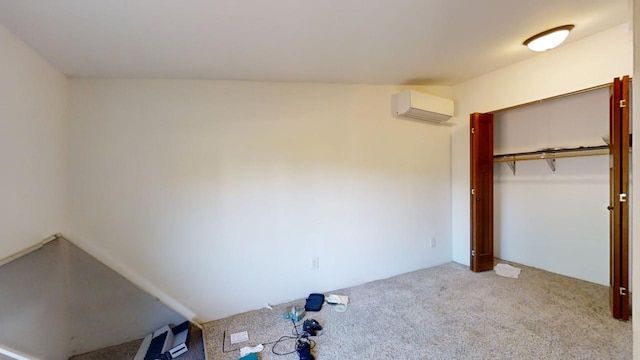 unfurnished bedroom with a closet, carpet flooring, and an AC wall unit