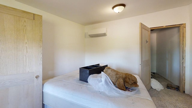 carpeted bedroom with a closet and a wall mounted air conditioner