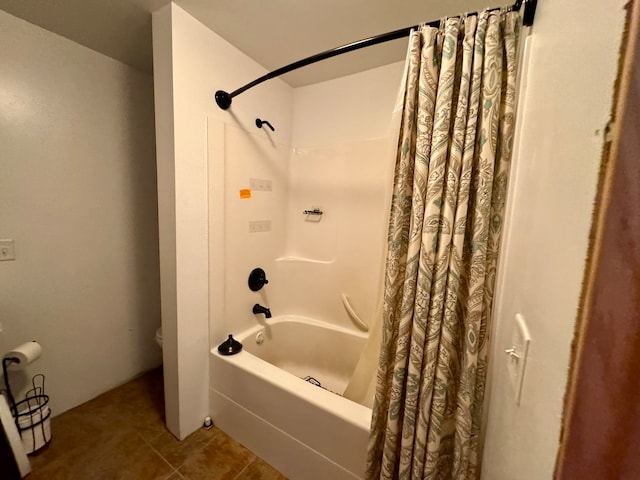 bathroom with toilet, shower / tub combo with curtain, and tile patterned floors