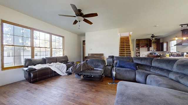 living room featuring ceiling fan, hardwood / wood-style flooring, and sink