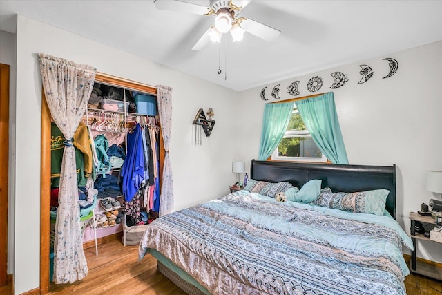 bedroom featuring wood-type flooring, a closet, and ceiling fan