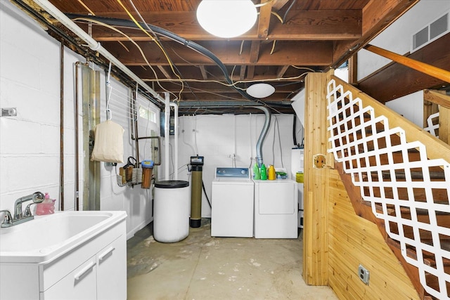 basement with washer and dryer and sink