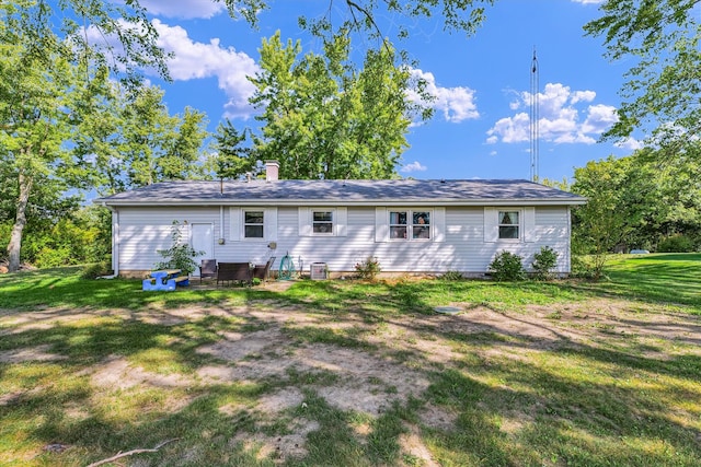 back of house with a lawn