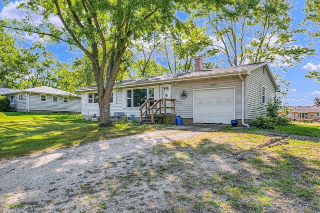 single story home with a garage and a front lawn