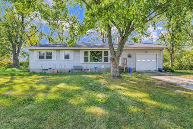 ranch-style house featuring a garage and a front lawn