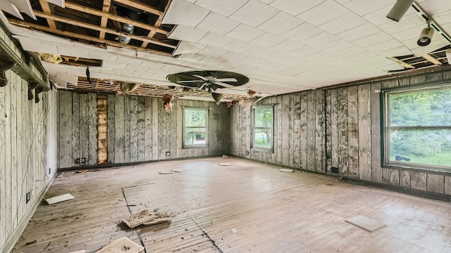 misc room featuring wood walls and a healthy amount of sunlight