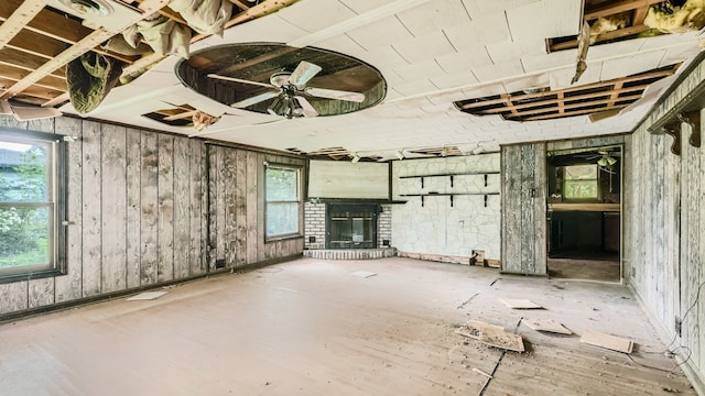 misc room with wood walls and a brick fireplace