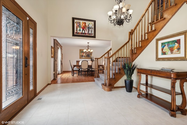 foyer with a wealth of natural light, an inviting chandelier, and light hardwood / wood-style floors