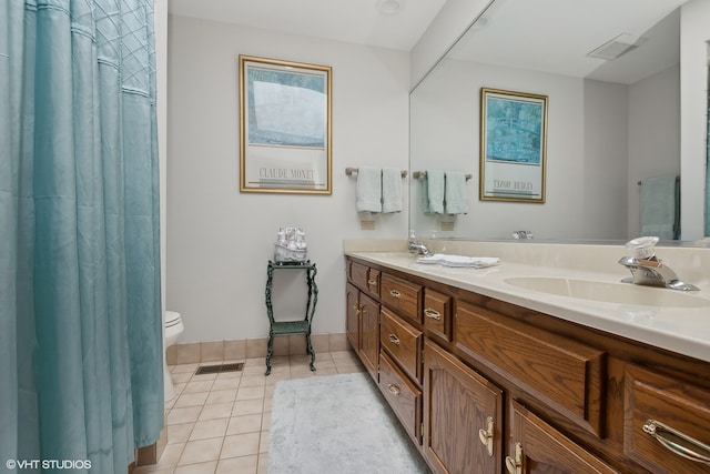 bathroom with vanity, toilet, and tile patterned flooring