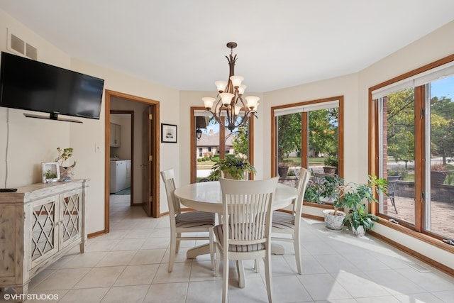 tiled dining room with an inviting chandelier